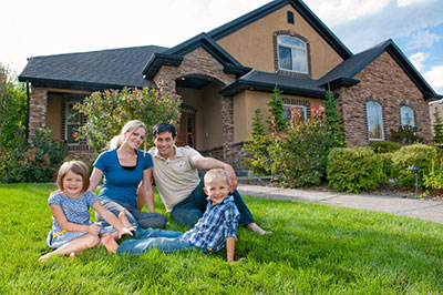 Family sitting infront of their house